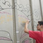 Student Derek Muller working on the public mural in Majuro. Photo © Christine Germano.