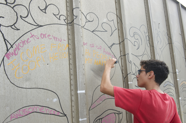 Student Derek Muller working on the public mural in Majuro. Photo © Christine Germano.